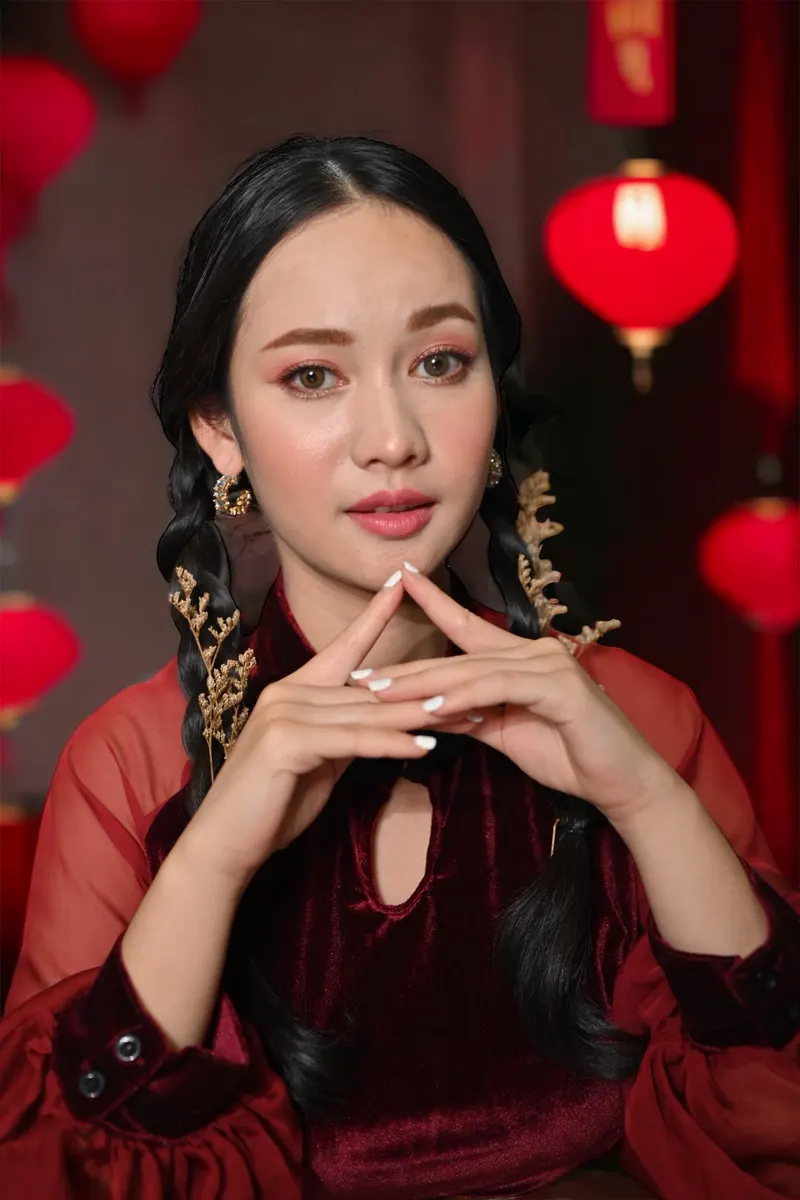 ภาพถ่ายแบบธีมตรุษจีน ประสานมือเล็บขาว ผมถักเปียสองข้าง ชุดกำมะหยี่สีแดงเข้มแขนซีทรู ฉากโคมแดง แต่งตาโทนน้ำตาลส้ม ลิปสีนู้ดชมพู